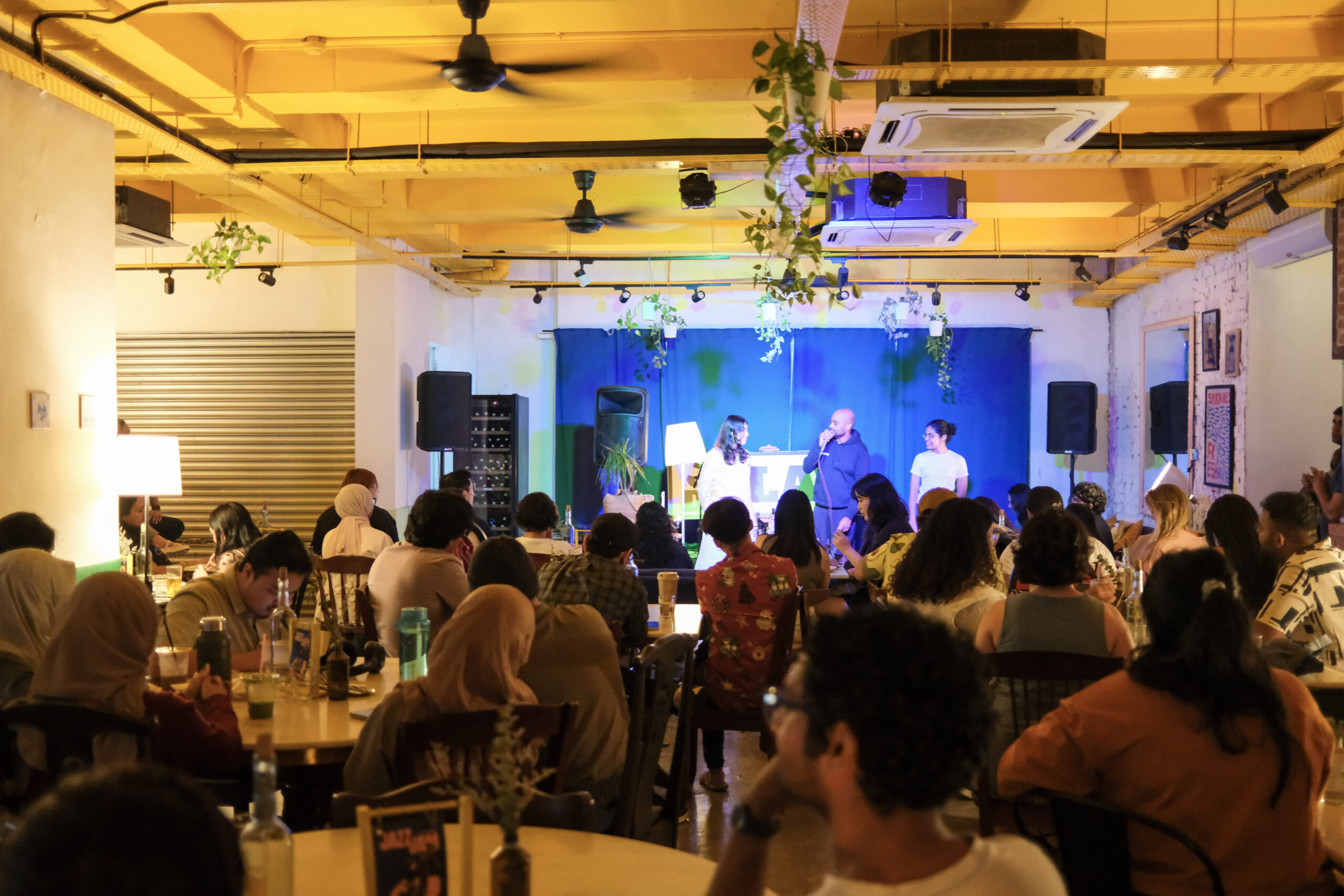 Performance evening at Bartolo Lisboa Bakehouse — performers on stage with packed dining room