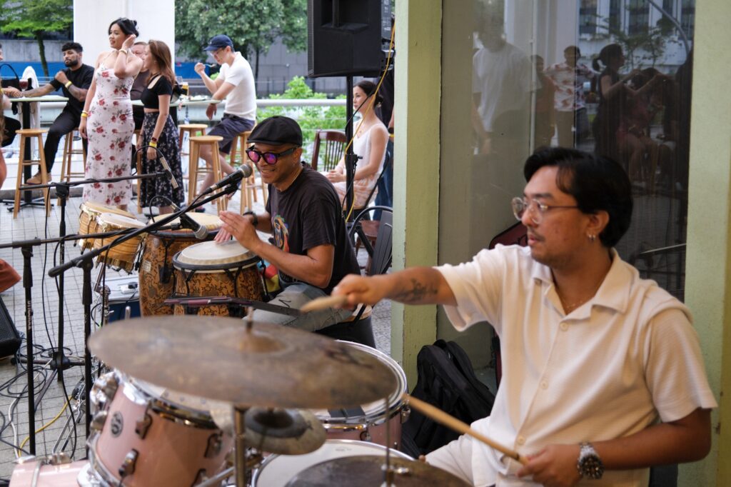 Live event at Bartolo Lisboa Bakehouse — drummers performing as guests dance outdoors