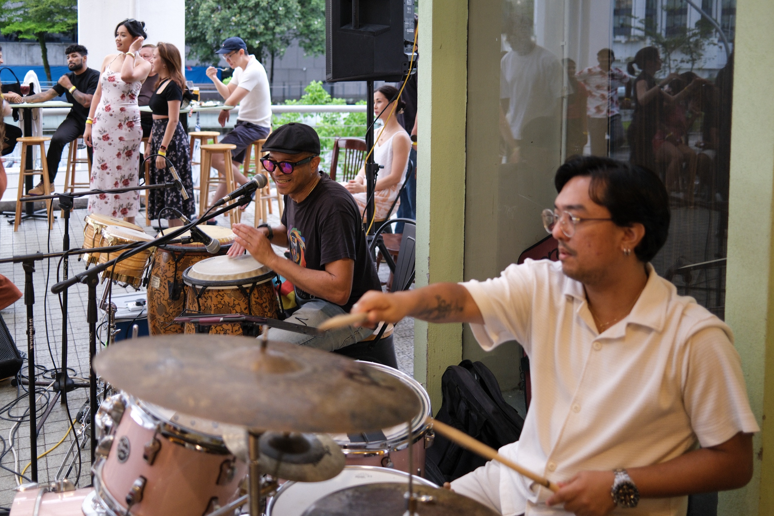 Live event at Bartolo Lisboa Bakehouse — drummers performing as guests dance outdoors