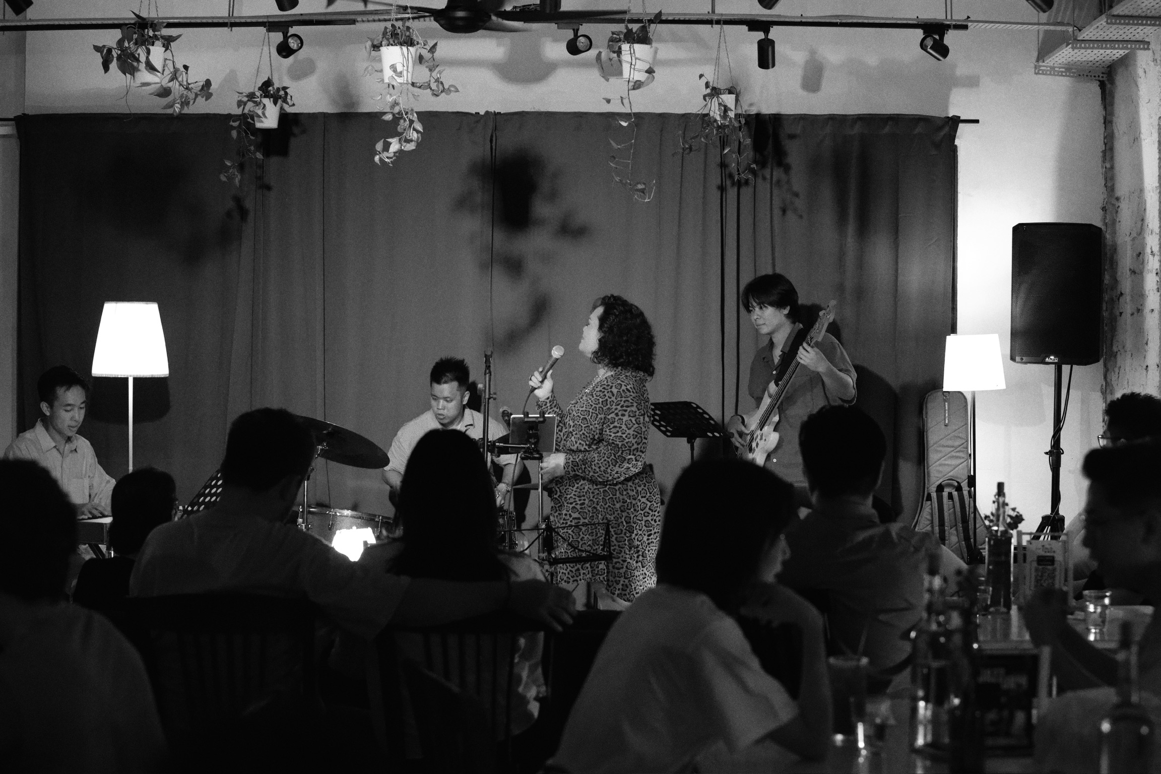 Live event at Bartolo Lisboa Bakehouse — full band performing for seated audience, black and white