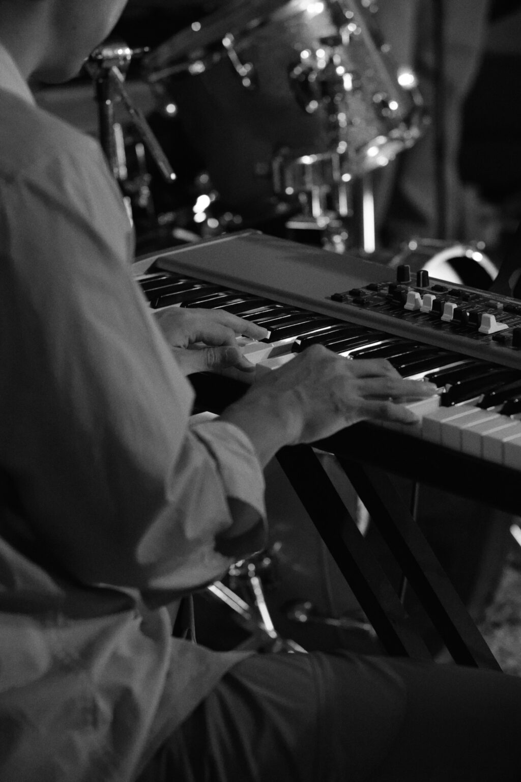 Close-up black-and-white of a keyboardist's hands at Bartolo Jazz Jam